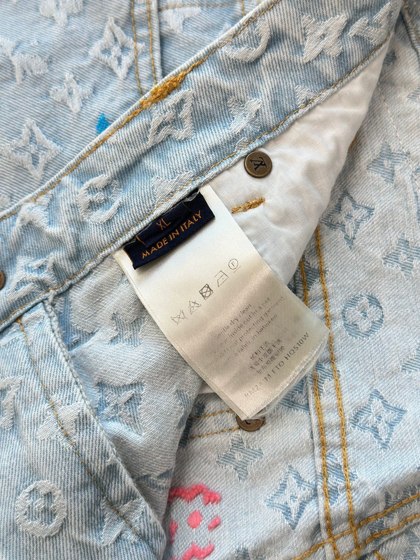 Light blue monogram denim shorts with inner care label and stitched waistband