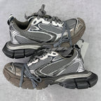 Chunky Balenciaga sneakers in gray and silver with mesh panels and lace-up front