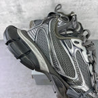 Side view chunky sneakers with gray mesh upper and dark rubber sole