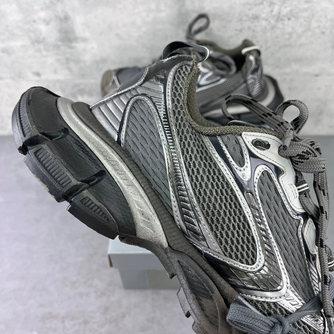Side view chunky sneakers with gray mesh upper and dark rubber sole