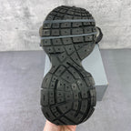 Shoe outsole view with a black tread pattern on a chunky rubber sole