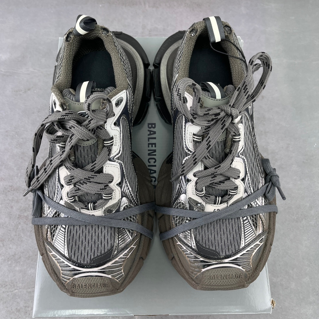 Pair of lace-up sneakers with gray mesh uppers and Balenciaga-branded heel panels