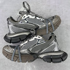 Front view pair of chunky lace-up sneakers in gray mesh with silver and black accents