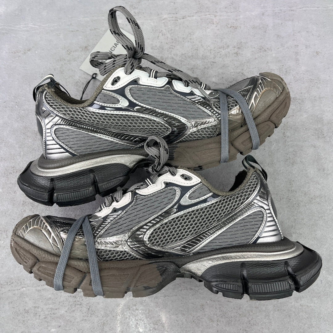 Front view pair of chunky lace-up sneakers in gray mesh with silver and black accents