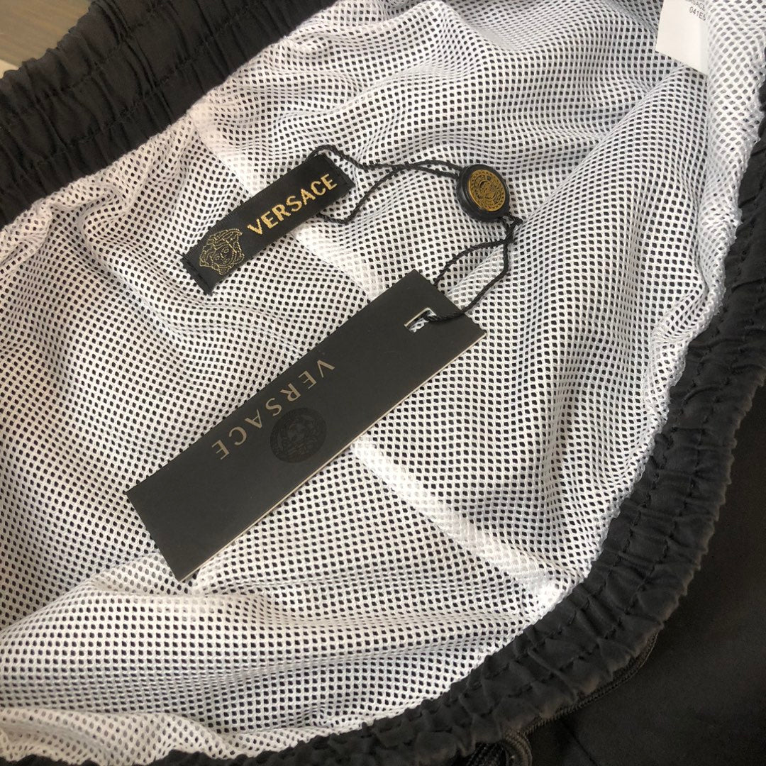 Black Versace shorts with mesh lining and inner waistband label