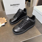 Black leather lace-up sneakers with embossed side logo and rubber sole