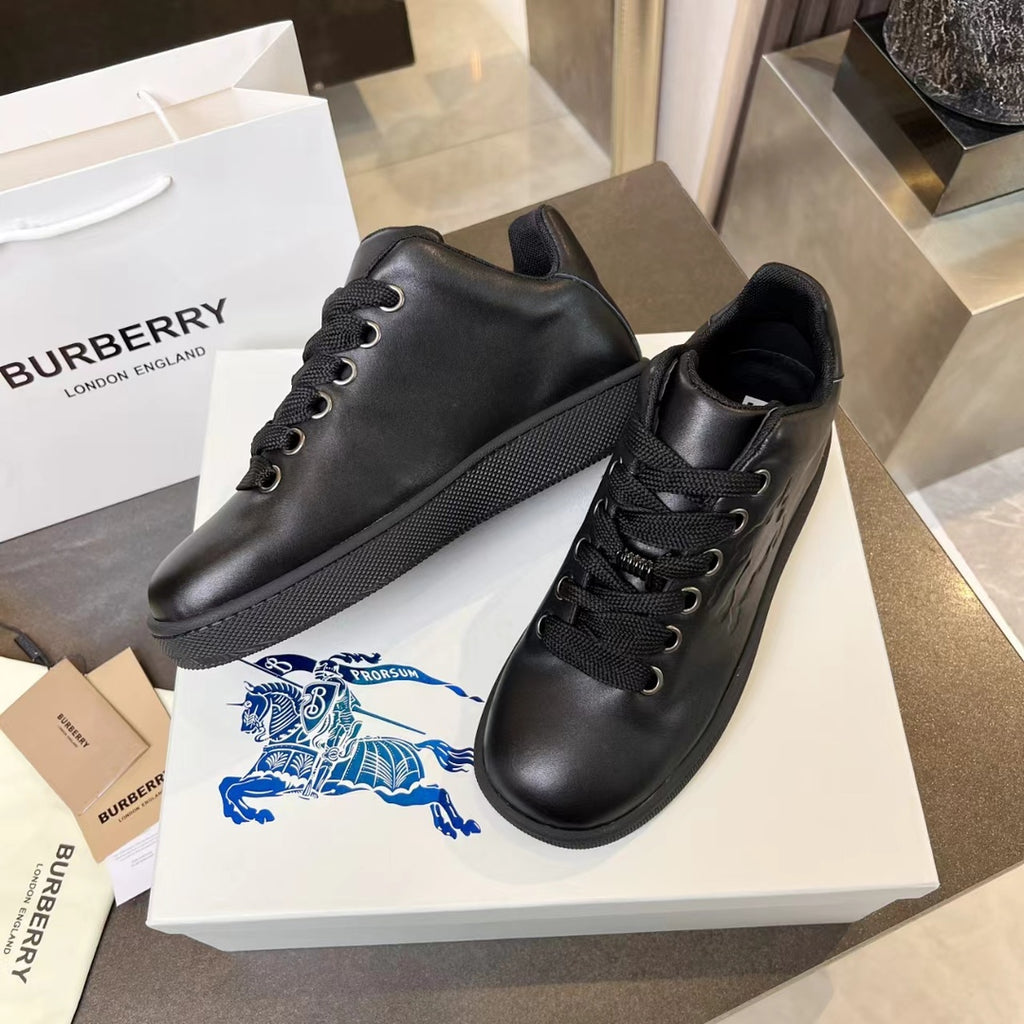 Black leather lace-up sneakers with textured side panel and cushioned sole
