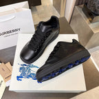 Black lace-up sneakers with embossed pattern and blue-accent outsole tread