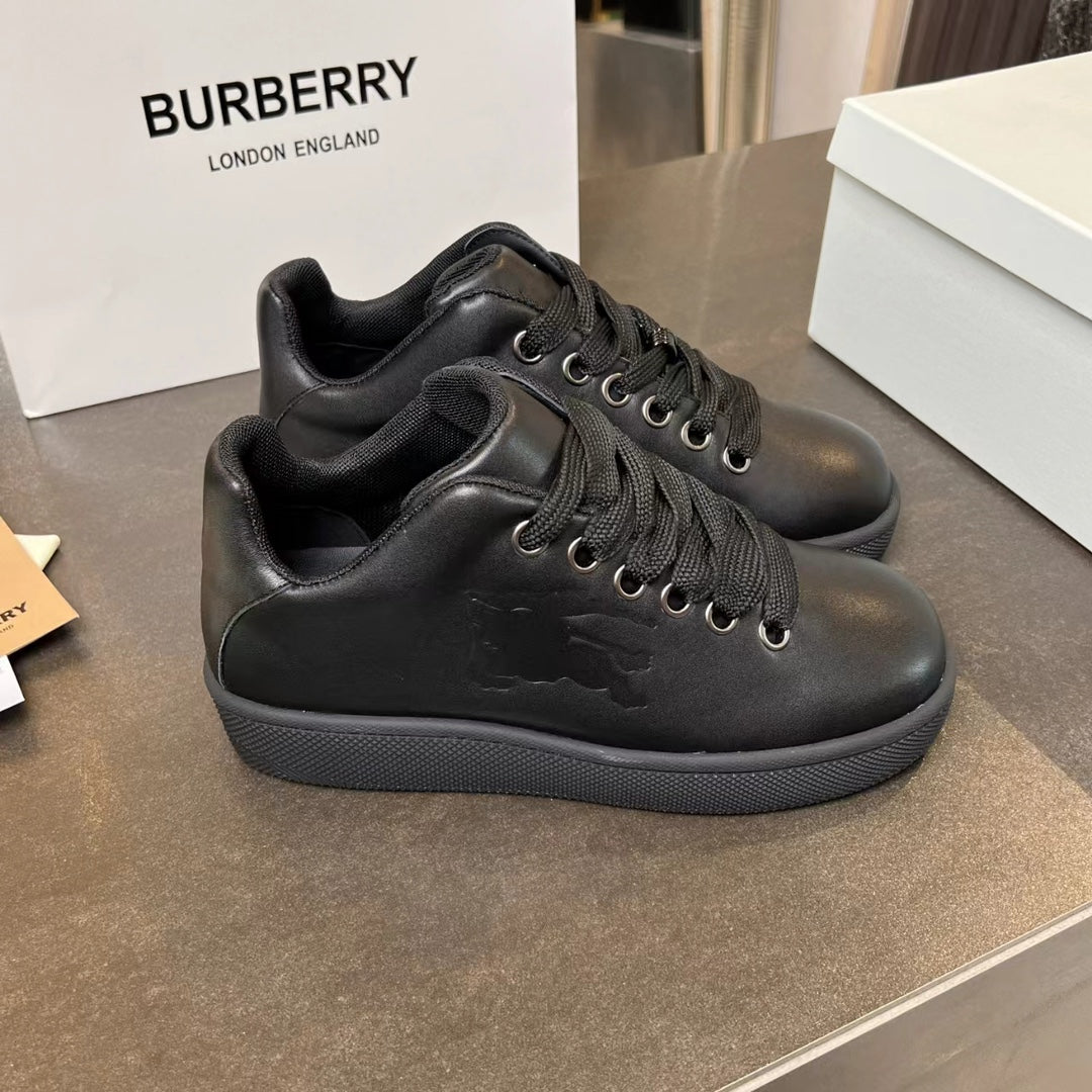 Black lace-up high-top sneakers with quilted-look paneling and dark rubber sole