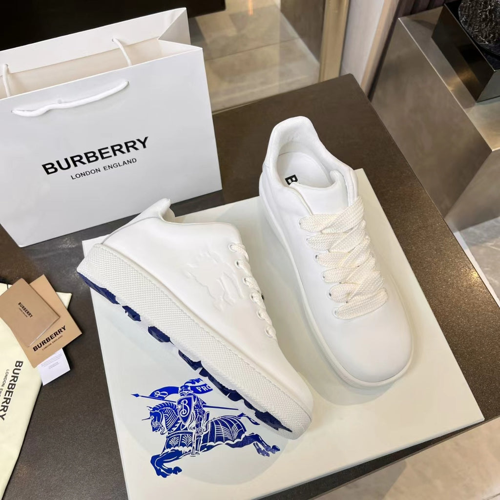 Pair of white low-top sneakers with textured side panel and blue logo graphic
