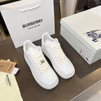 Pair of white low-top sneakers with lace-up front and small logo hardware