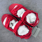 Red Balenciaga sandals with wide hook-loop straps and white tissue inserts
