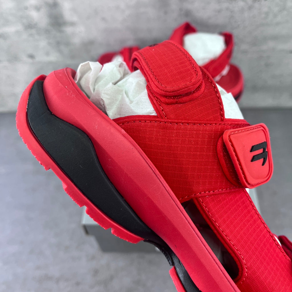 Red Balenciaga sandal with wide strap and black-trimmed rubber sole
