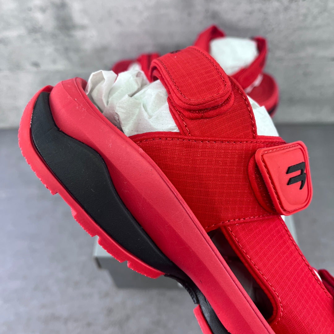 Red Balenciaga sandal with wide strap and black-trimmed rubber sole