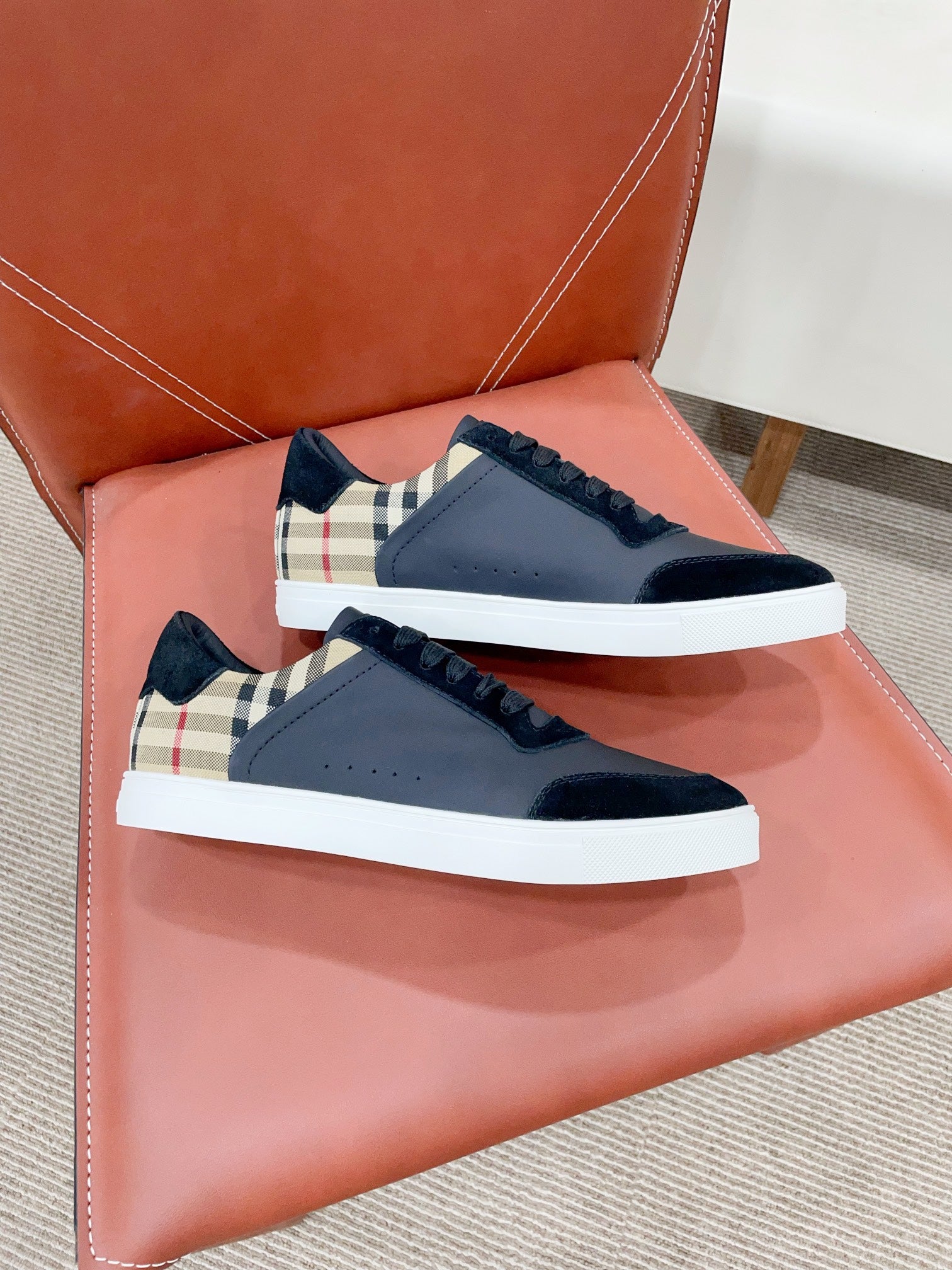 Navy leather sneakers with black laces, check detail, and white midsole