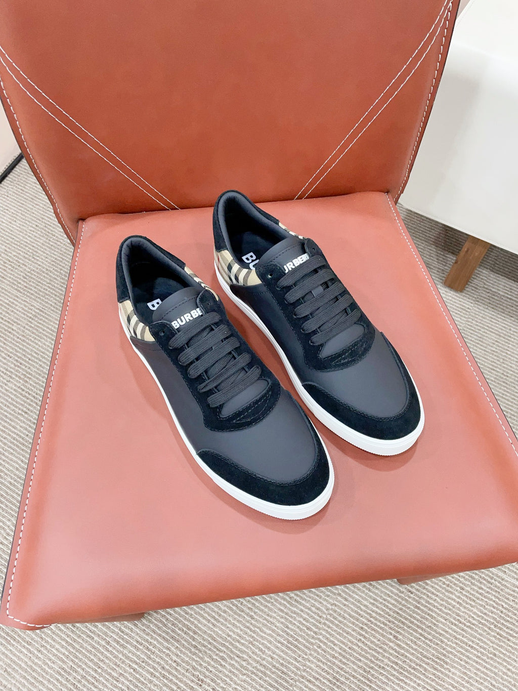 Navy lace-up sneakers with check-pattern panels and white rubber soles
