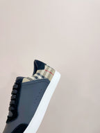 Navy leather sneaker with check-pattern collar detail and white rubber sole
