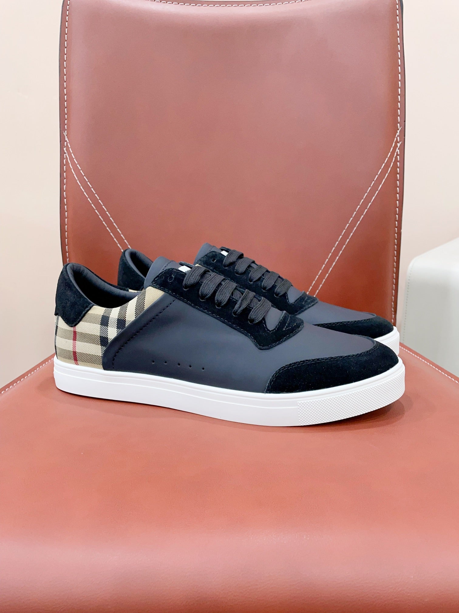 Navy leather sneakers with lace-up front and white rubber sole