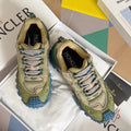Moncler lace-up sneakers in olive with blue rugged sole, shown on white box inserts