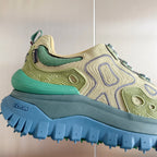 Moncler sneaker close-up: olive and green upper with blue Vibram-style tread sole