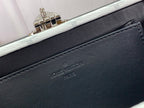 Louis Vuitton embossed logo on black leather trim with metal clasp edge