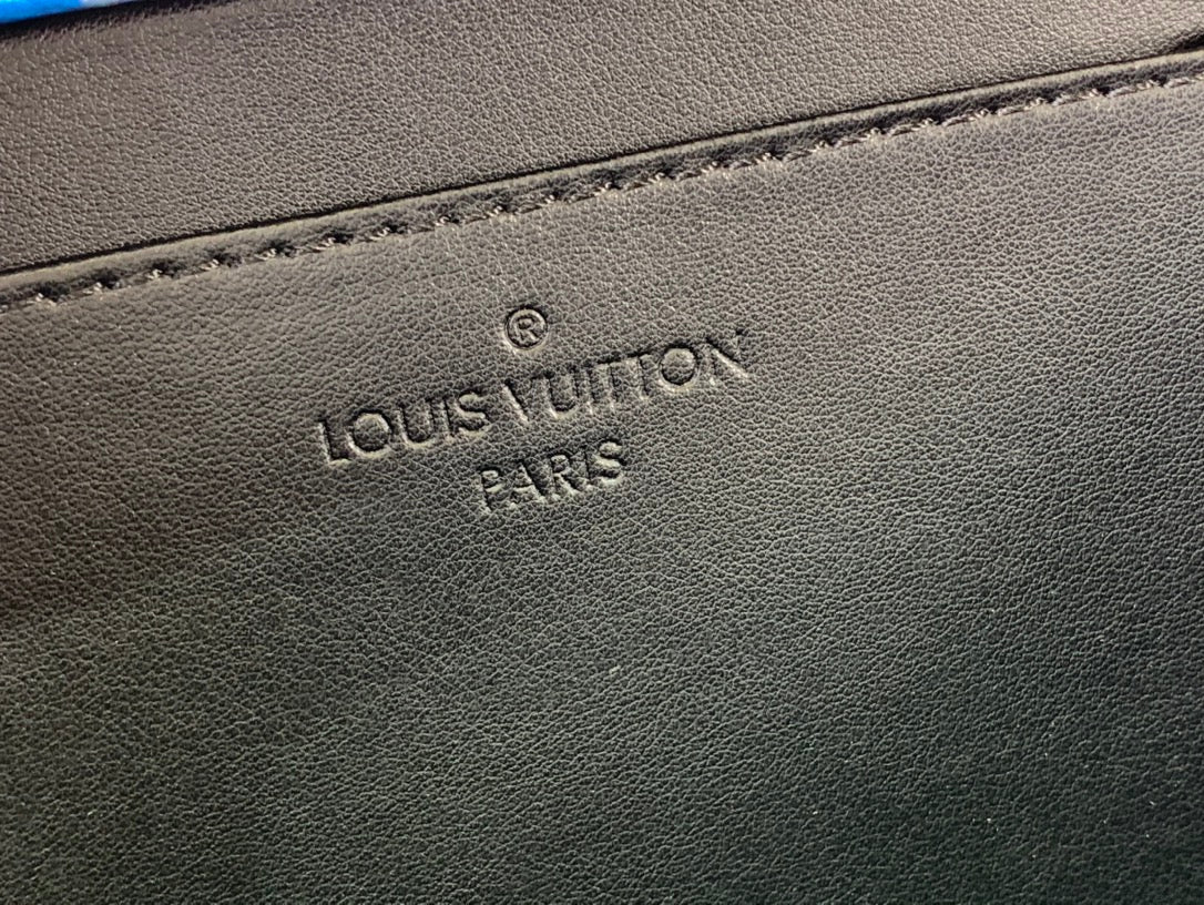 Louis Vuitton Paris embossed on dark leather bag base