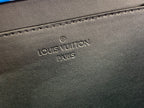 Embossed “Louis Vuitton Paris” on dark leather bag exterior close-up