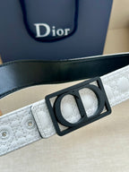 White belt close-up with black rectangular buckle and perforated strap holes.