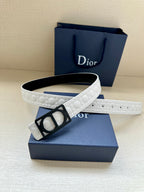 White leather belt with black Dior buckle resting on gift box, side view.