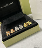 Clover charm bracelet with gold and silver flower motifs