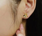 Gold clover stud earrings with small crystal accents