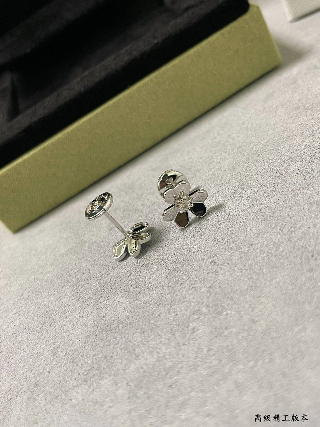 Silver clover stud earrings with crystal flower detail