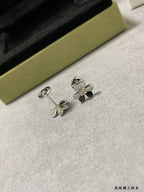 Silver clover stud earrings with crystal flower detail