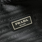 Prada Milano black textured bag label on front plate