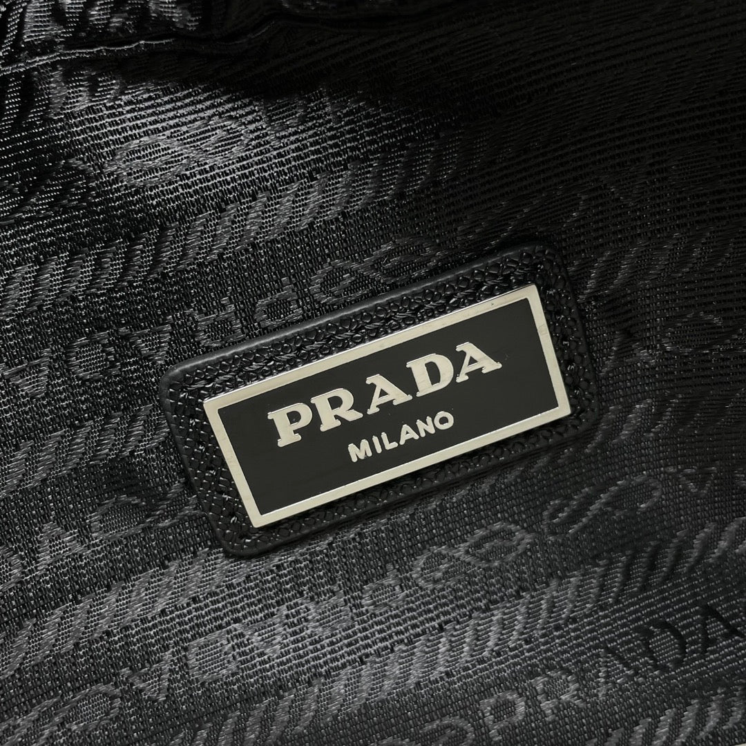 Prada Milano black textured bag label on front plate