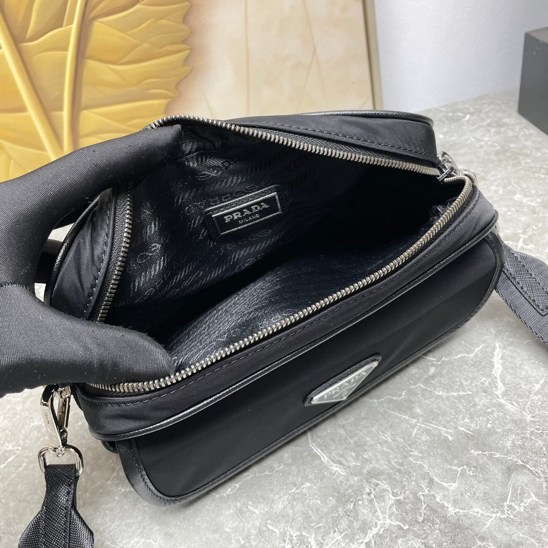 Prada black crossbody bag interior with zipper opening and logo patch