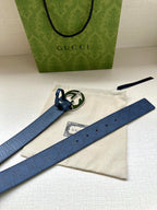 Gucci belt on white pouch with dark blue strap and small silver interlocking G buckle