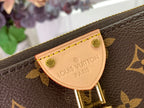 Louis Vuitton monogram bag logo plate on brown canvas with tan stitching and gold trim