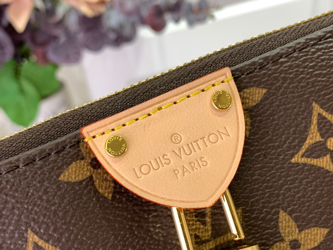 Louis Vuitton monogram bag logo plate on brown canvas with tan stitching and gold trim
