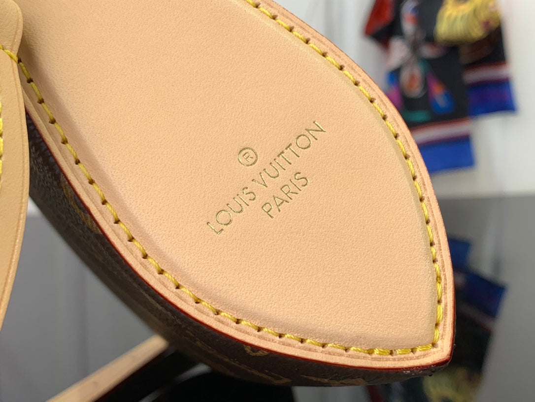 Louis Vuitton interior leather label with “Louis Vuitton Paris” text and tan edge stitching