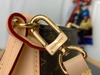 Louis Vuitton monogram bag clasp with tan strap and gold hardware, close-up