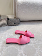 Pink Balenciaga slide sandals with low heel, side view