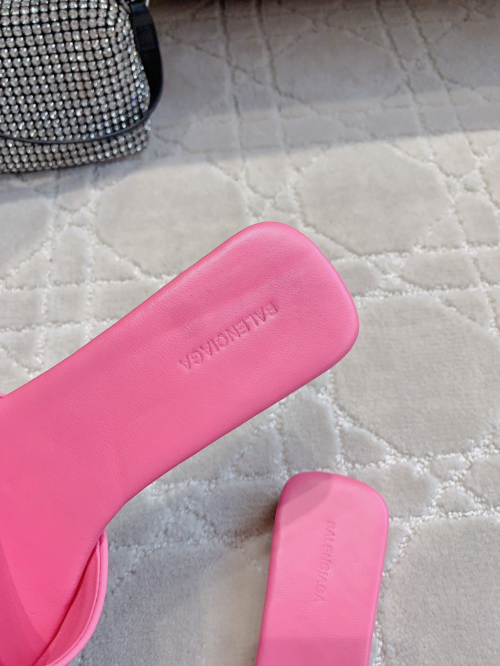 Pink Balenciaga slide sandal footbed with embossed lettering