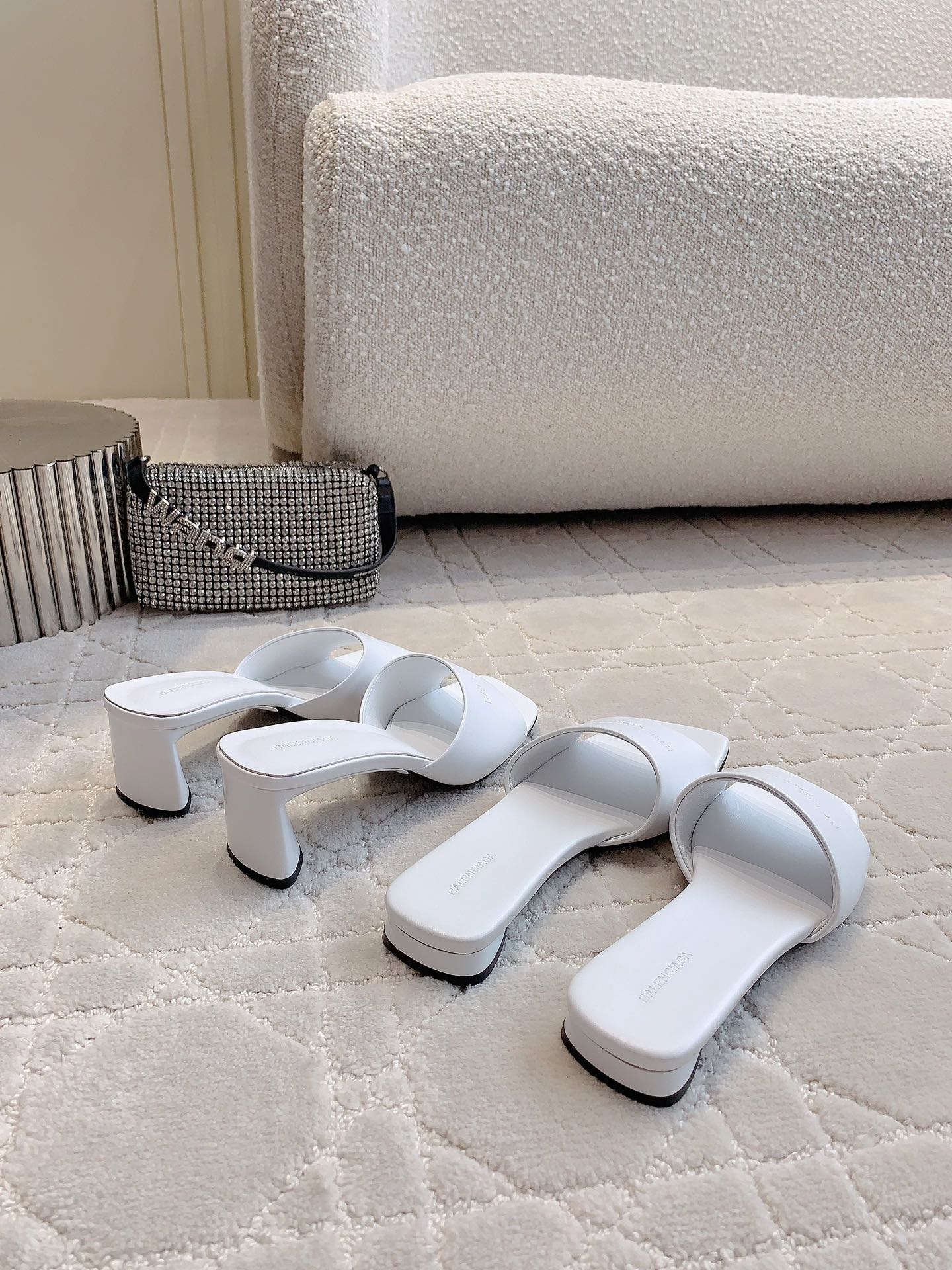 White Balenciaga slide sandals pair with mid-height block heel
