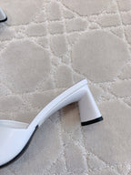 Balenciaga white sandals showing black heel detail and curved sole