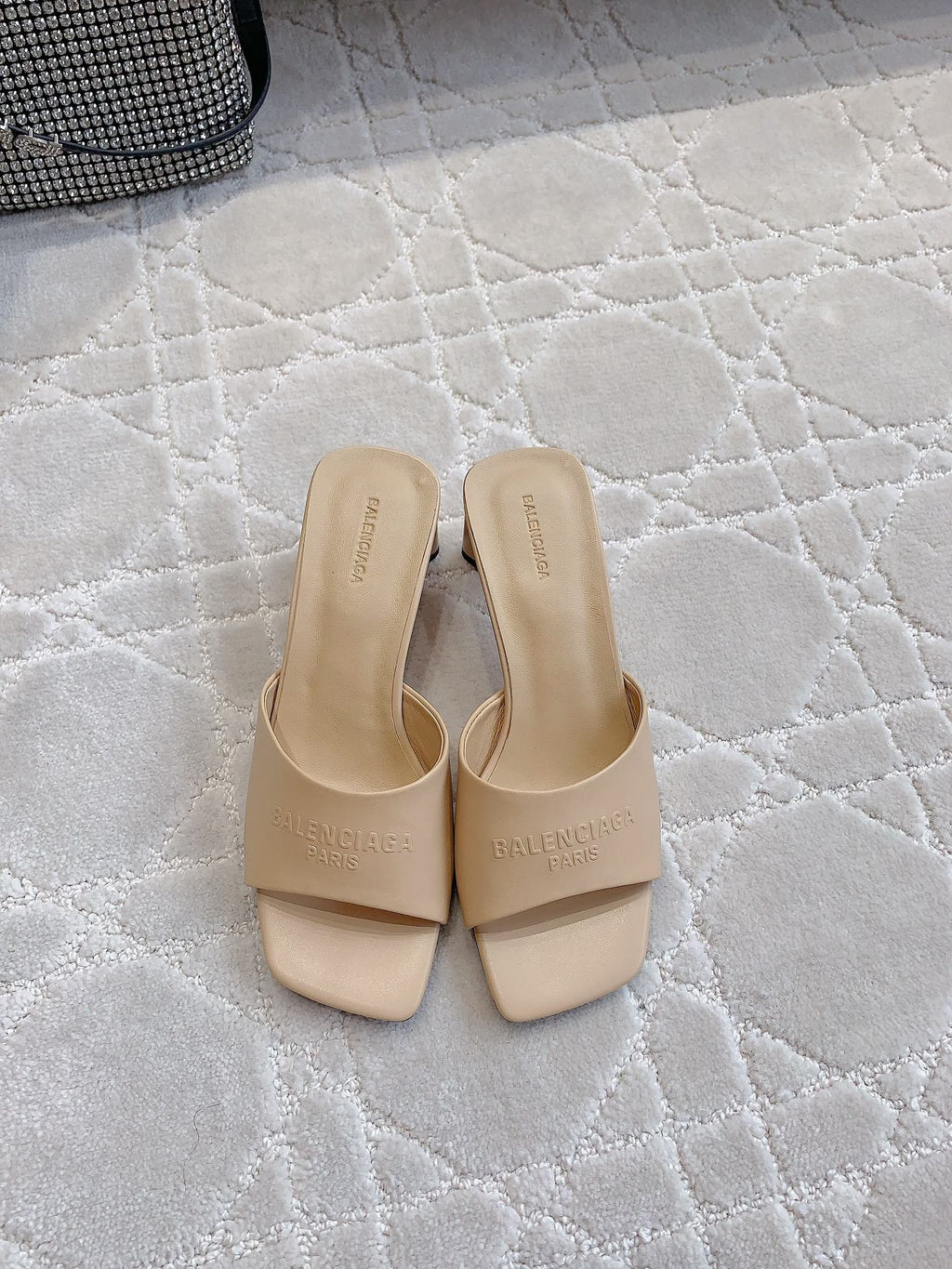 Beige slip-on slide sandals with wide straps and square toe, front view