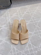 Beige slip-on slide sandals with wide straps and square toe, front view