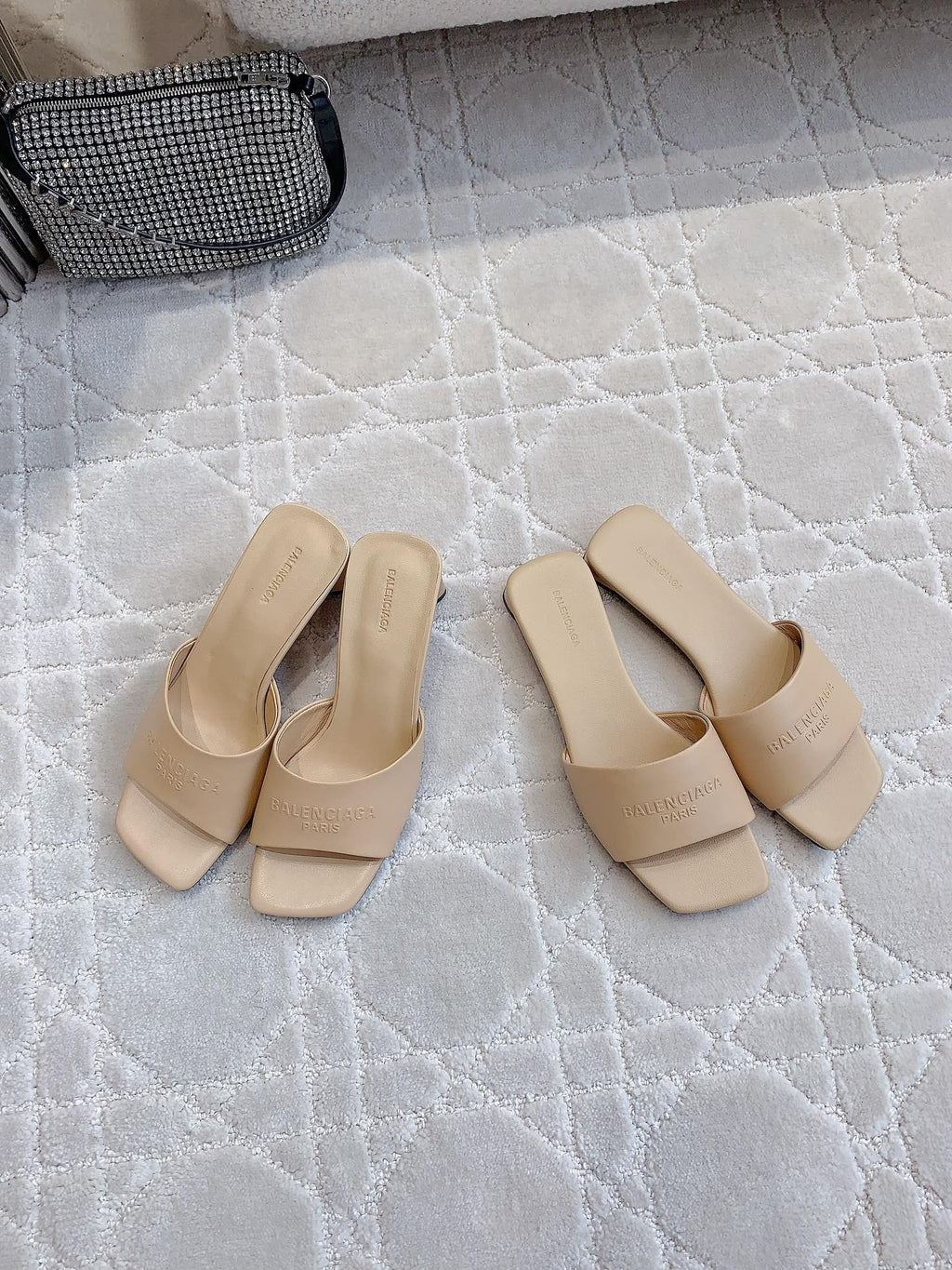 Beige slip-on slide sandals with square toe and embossed logo