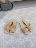 Beige slip-on slide sandals with square toe and embossed logo