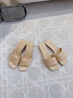 Beige slip-on slide sandals with square toe and embossed logo